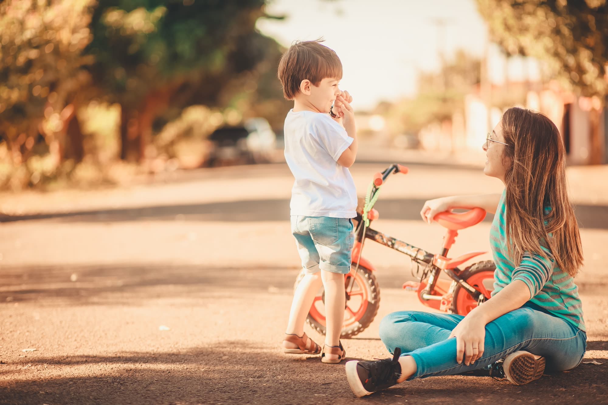 Two children playing together outside in warm light