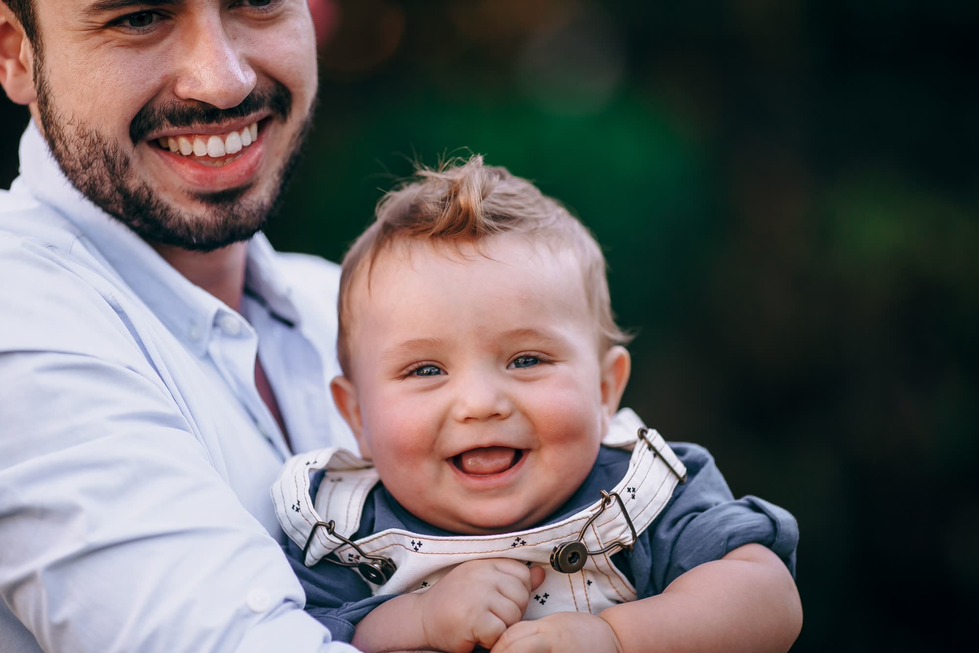 A caregiver smiling with a happy baby